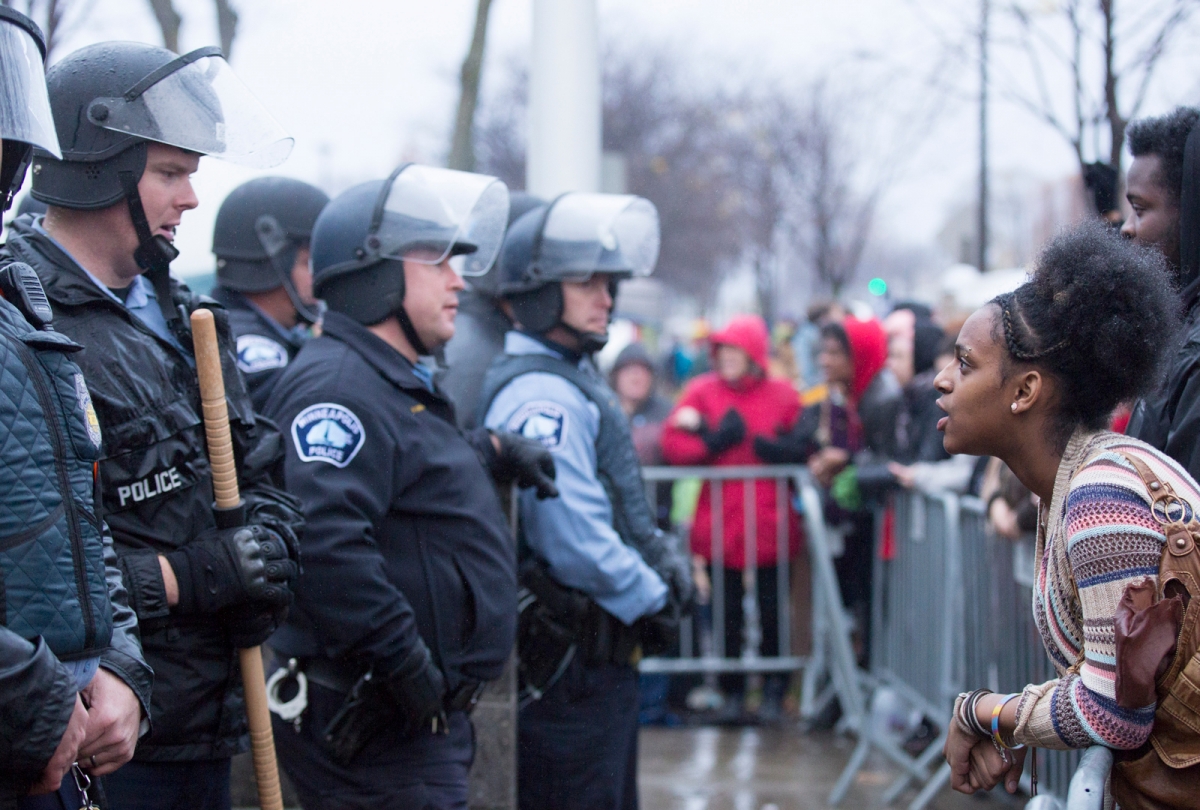 Police and protesters engage in a tense standoff at the 4th police precinct after the killing of Jamar Clark, November 18, 2015